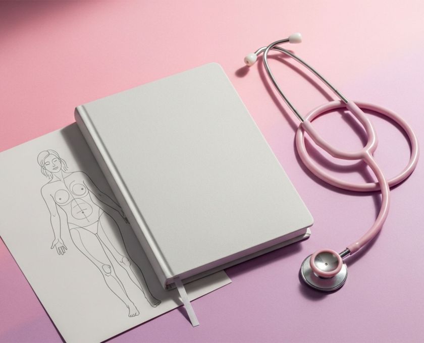 Pastel flat lay with journal, stethoscope, and vulva anatomy card on soft pink background