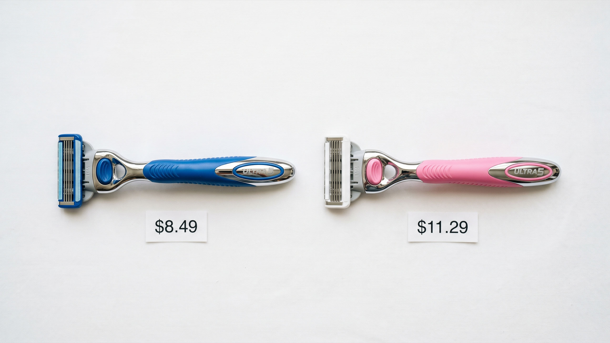 Pink and blue razors side by side with price tags showing the cost difference — the pink tax illustrated