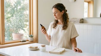 Woman reviewing hygiene products at a clean bathroom counter, representing microbiome-informed self-care