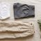 Flat-lay of cotton underwear, linen skirt, and activewear shorts on a neutral surface