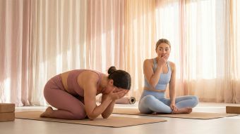 A woman in a peaceful yoga setting practicing mindful movement.