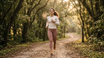Woman running at golden hour, illustrating how the female body burns fuel differently from men