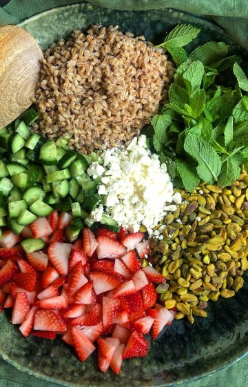 Colorful bowl of healing foods including greens, grains, and herbs for women&rsquo;s nutrition