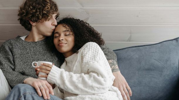 Couple sitting on a sofa having a calm, supportive conversation